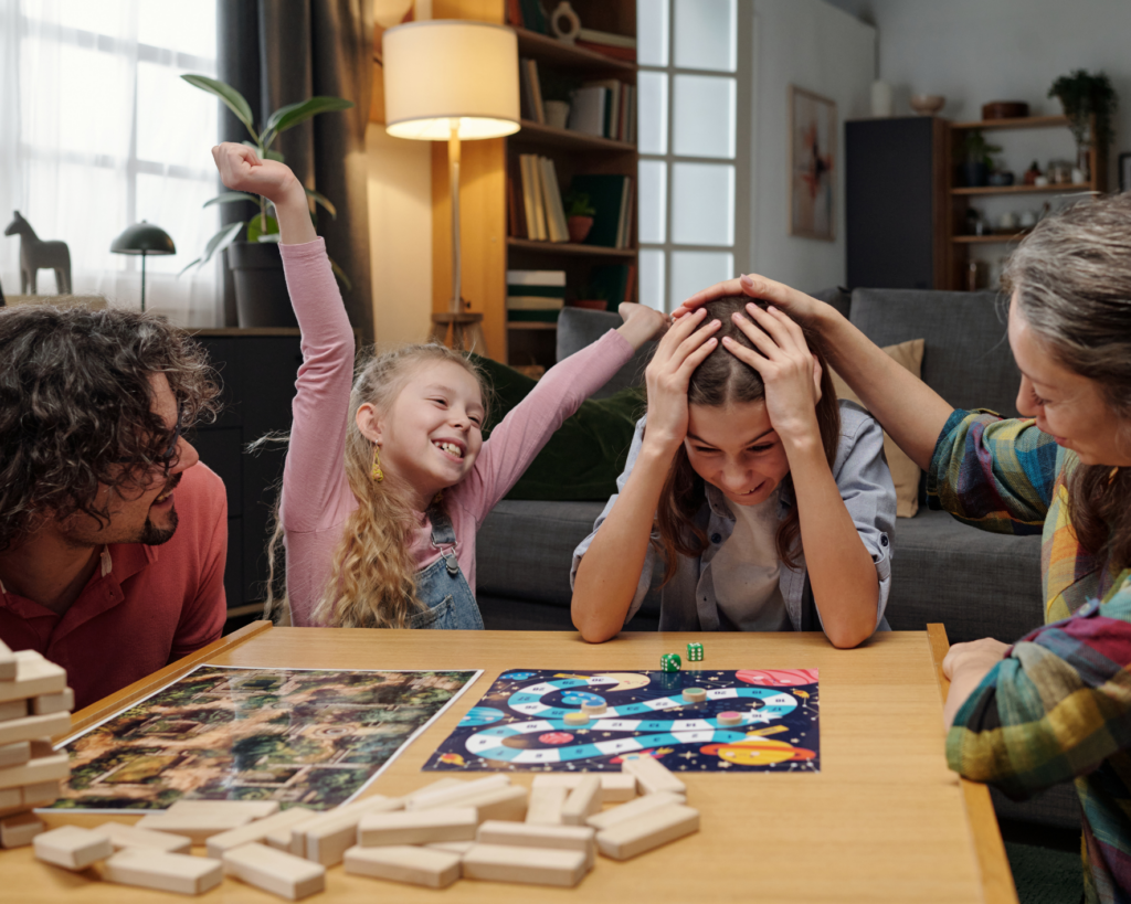 Family playing a board game together, enjoying quality time and illustrating the value of finding ways to buy back your time.